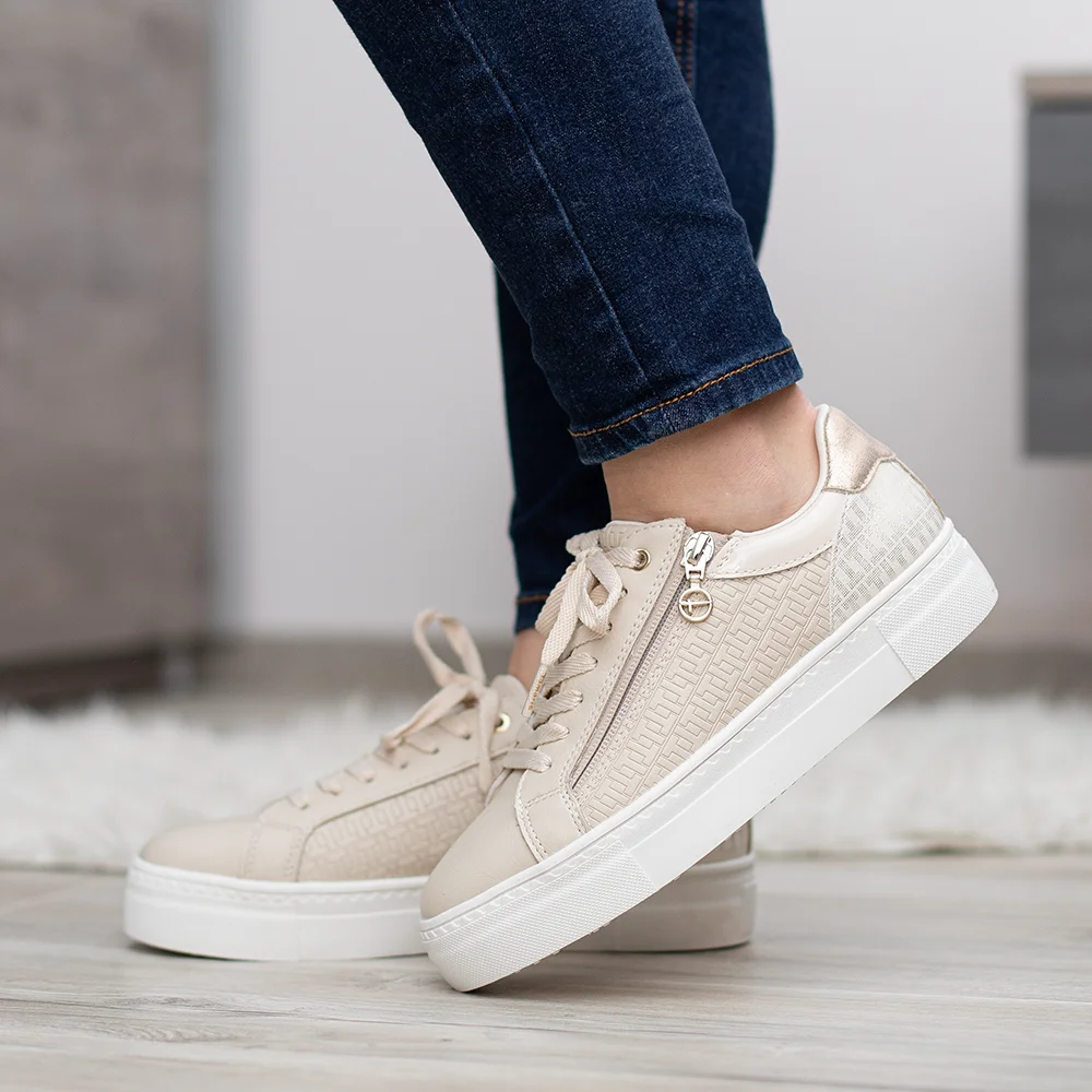 • Tamaris női tornacipő lapos talppal • Világos felsőrésszel készült, arany színű kiegészítőkkel • Fűzős utcai sportcipő komfortos kivitelben